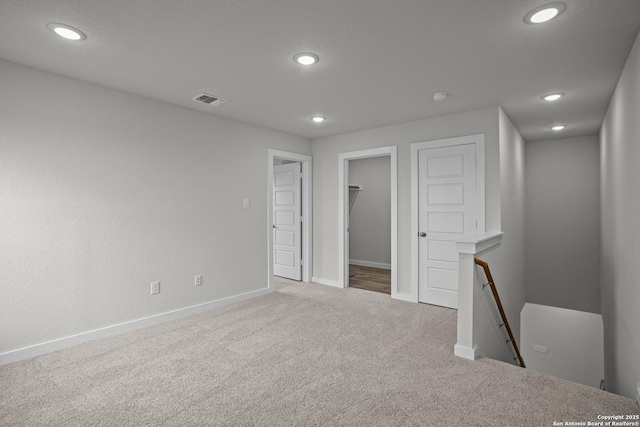 unfurnished room featuring carpet, recessed lighting, baseboards, and a smoke detector