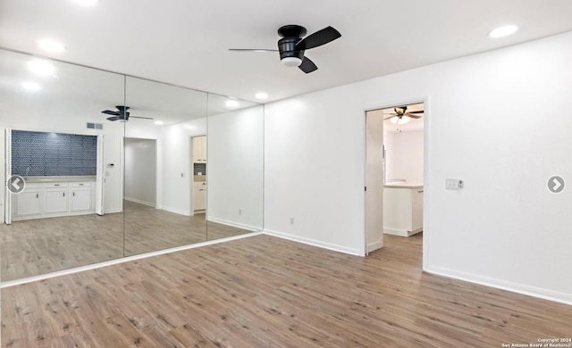 interior space featuring visible vents, ceiling fan, and wood finished floors