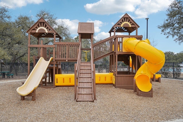 view of jungle gym featuring fence