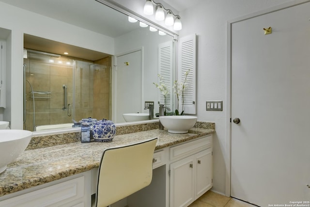 full bathroom featuring a stall shower, vanity, and tile patterned floors