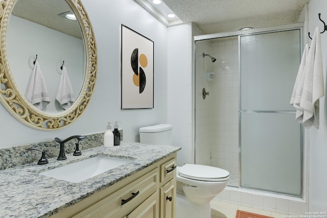 full bathroom with a textured ceiling, tile patterned flooring, toilet, vanity, and a shower stall