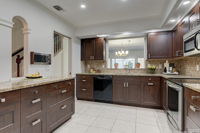 kitchen with light tile patterned floors, stainless steel appliances, visible vents, decorative backsplash, and a sink