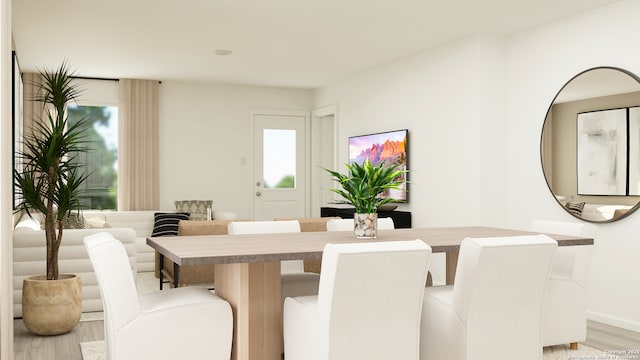 dining space with plenty of natural light and light wood-style floors