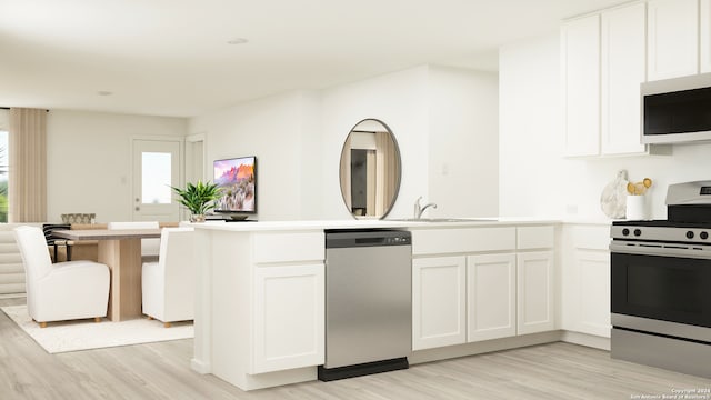 kitchen with light wood finished floors, white cabinets, appliances with stainless steel finishes, light countertops, and a sink