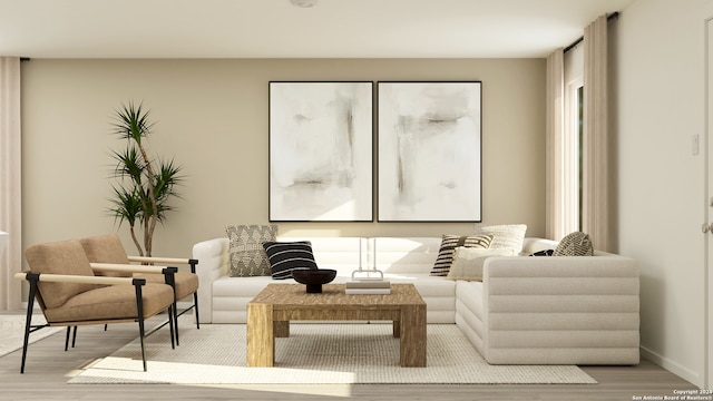 sitting room featuring baseboards and light wood-style floors