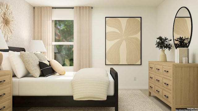 bedroom with baseboards and light colored carpet