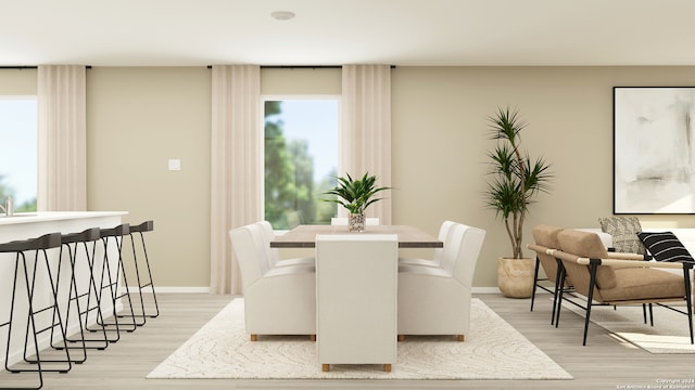 dining room with light wood-style flooring and baseboards