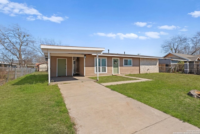 view of front of home with a front yard, concrete driveway, and fence