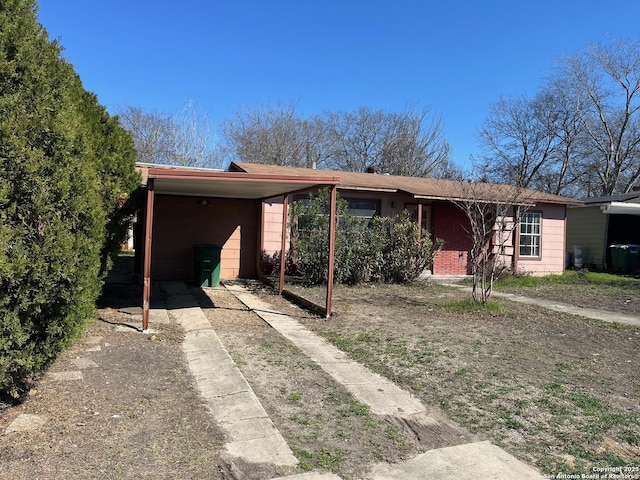 single story home with a carport and driveway