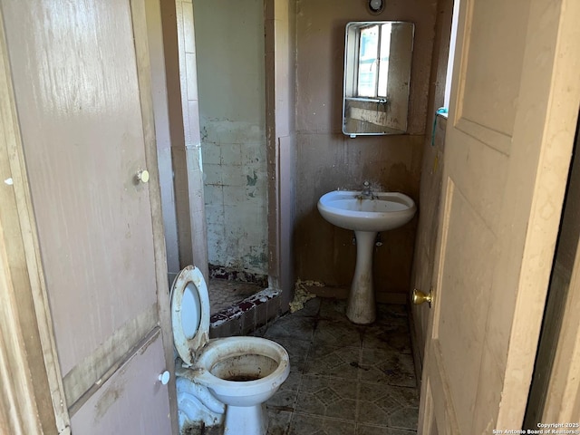 full bathroom with a stall shower and toilet