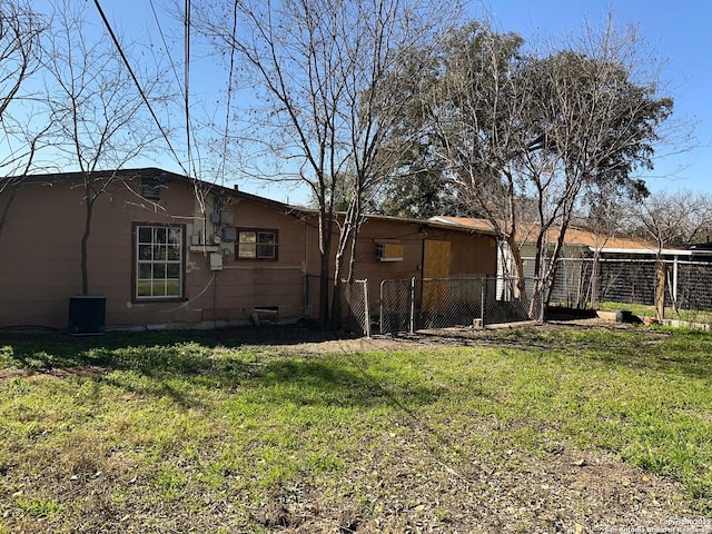 exterior space with fence and a lawn