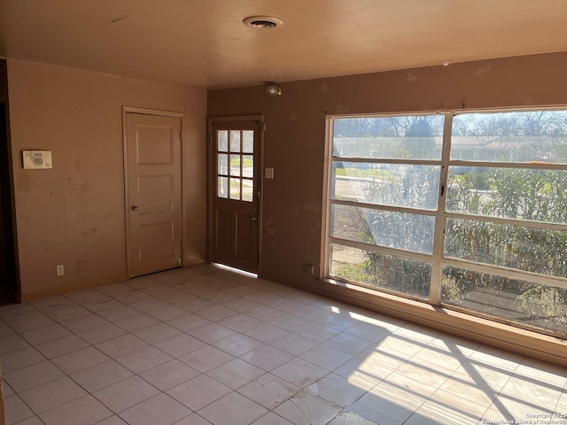 foyer featuring light tile patterned floors and visible vents