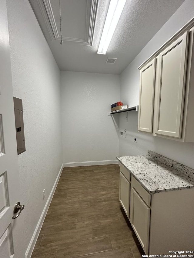 laundry room featuring cabinet space, attic access, dark wood-type flooring, hookup for a washing machine, and hookup for an electric dryer