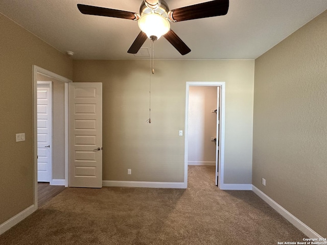 unfurnished bedroom featuring a ceiling fan, baseboards, and carpet flooring