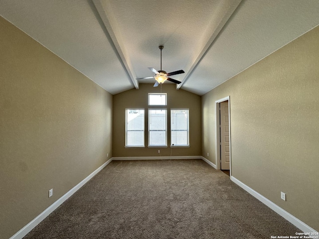 empty room featuring carpet, ceiling fan, lofted ceiling, and baseboards