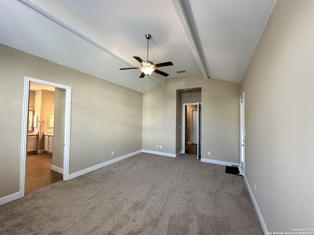 unfurnished bedroom with lofted ceiling with beams, carpet, visible vents, and baseboards