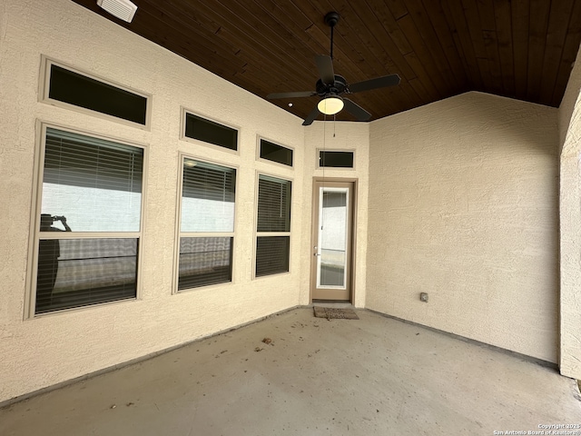 doorway to property featuring ceiling fan, a patio, and stucco siding