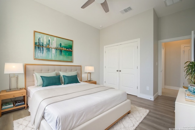 bedroom featuring a closet, visible vents, and wood finished floors