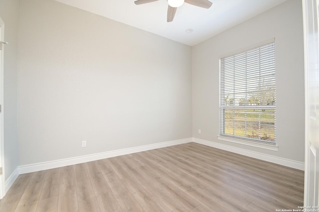 unfurnished room with a ceiling fan, light wood-type flooring, and baseboards