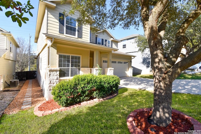 view of front facade with central AC unit, a front yard, fence, a garage, and driveway