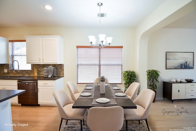 dining room with light wood-style flooring, recessed lighting, visible vents, and an inviting chandelier