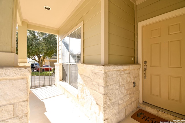 view of exterior entry featuring a porch