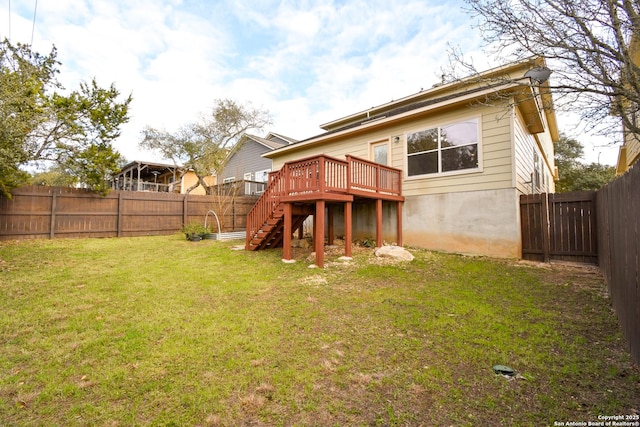 rear view of property featuring a fenced backyard, a yard, stairway, and a wooden deck