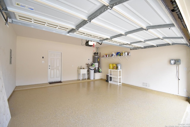 garage with water heater, a sink, visible vents, and a garage door opener