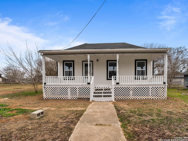 bungalow-style house featuring covered porch and a shingled roof