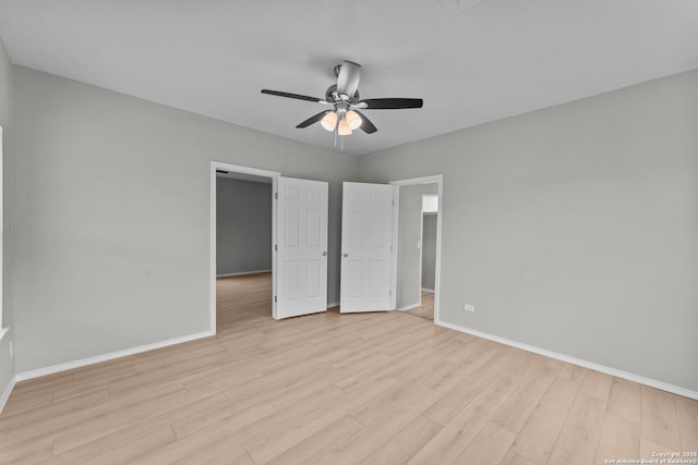 unfurnished bedroom with light wood-style floors, ceiling fan, and baseboards