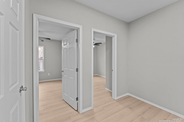 hallway with light wood finished floors and baseboards