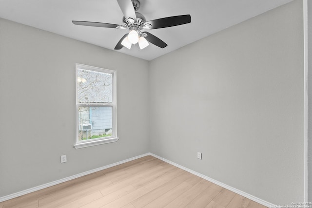 spare room with light wood-style floors, ceiling fan, and baseboards