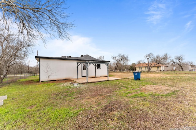 rear view of property with fence and a yard