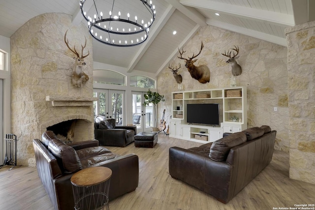 living area featuring high vaulted ceiling, french doors, wood finished floors, and beam ceiling