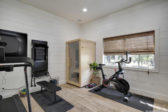 exercise area with recessed lighting, wood finished floors, and baseboards