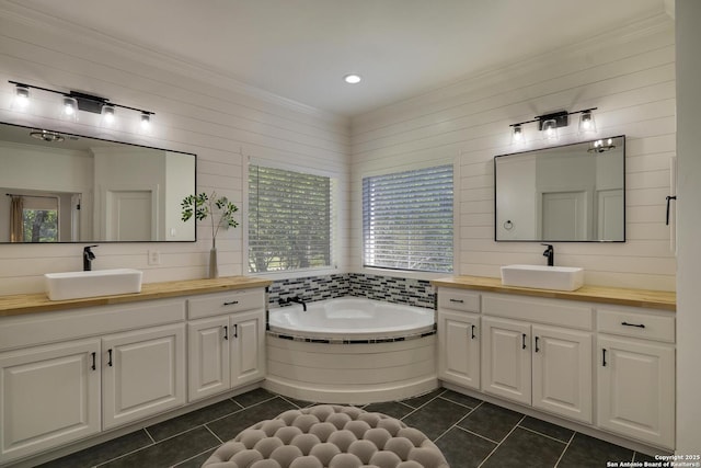 bathroom featuring ornamental molding, a sink, and tile patterned floors