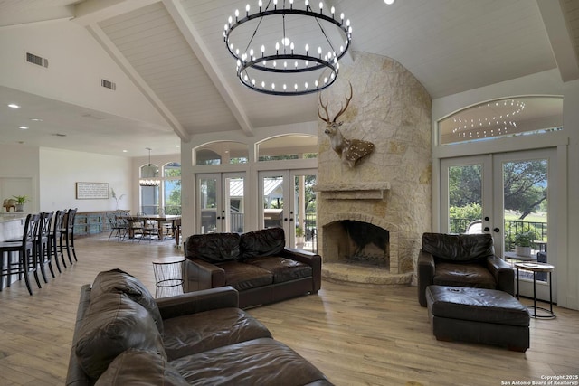 living area featuring french doors, visible vents, and wood finished floors