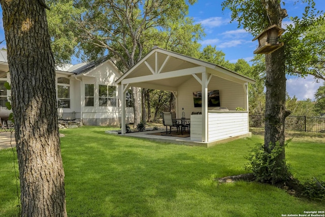 back of property with a patio area, fence, and a lawn