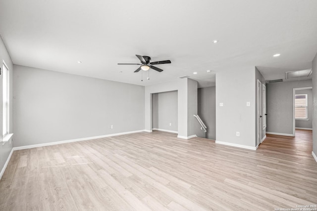 empty room featuring ceiling fan, recessed lighting, baseboards, light wood finished floors, and attic access