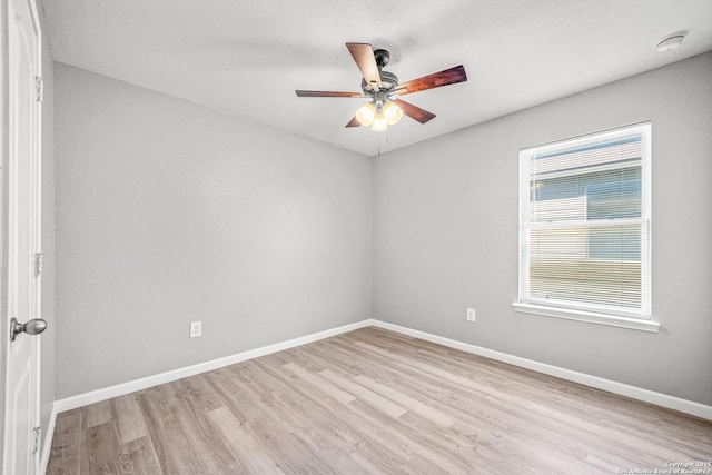 unfurnished room with light wood-style floors, baseboards, and a ceiling fan