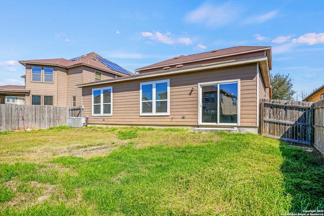 back of property featuring a yard and fence