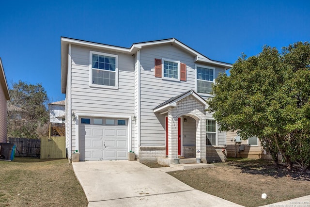 traditional-style house with a garage, brick siding, fence, concrete driveway, and a front lawn