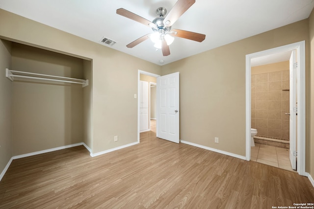 unfurnished bedroom with light wood-style floors, baseboards, visible vents, and a closet