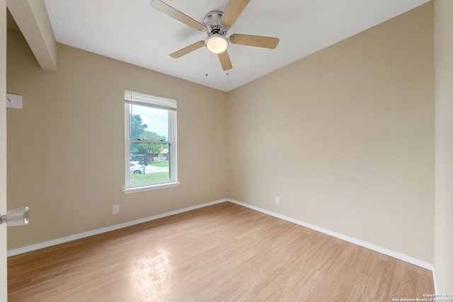 unfurnished room featuring baseboards, a ceiling fan, and light wood-style floors