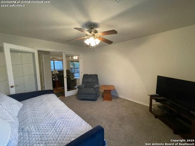 carpeted bedroom featuring ceiling fan and baseboards