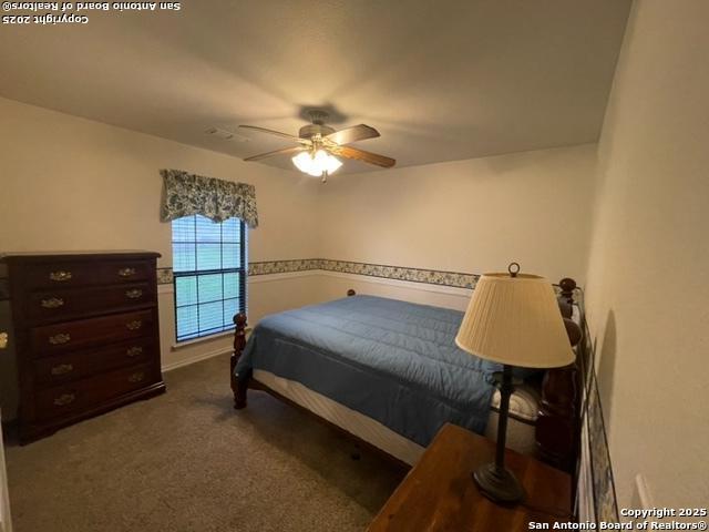 bedroom featuring carpet and a ceiling fan