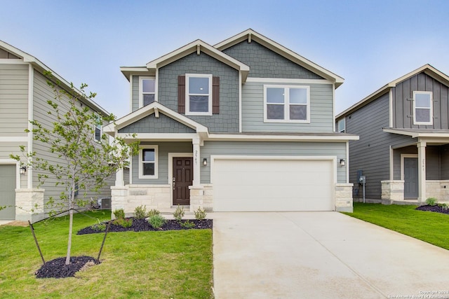 craftsman-style house with a garage, a front yard, driveway, and central AC unit