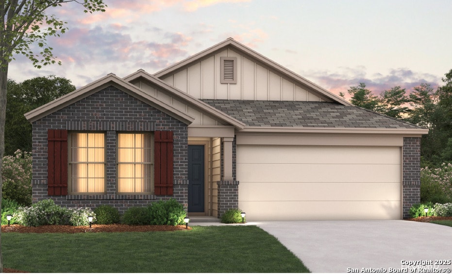 view of front of property with driveway, an attached garage, a yard, board and batten siding, and brick siding