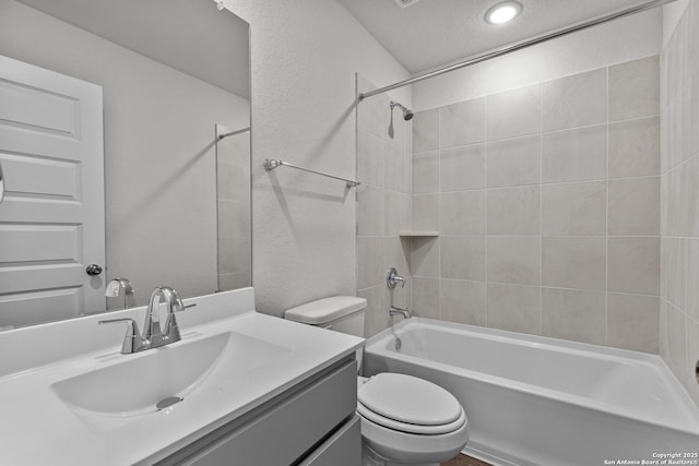 bathroom featuring shower / bathtub combination, a textured wall, toilet, a textured ceiling, and vanity