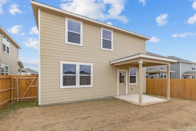 rear view of house featuring a patio area, a fenced backyard, and a lawn